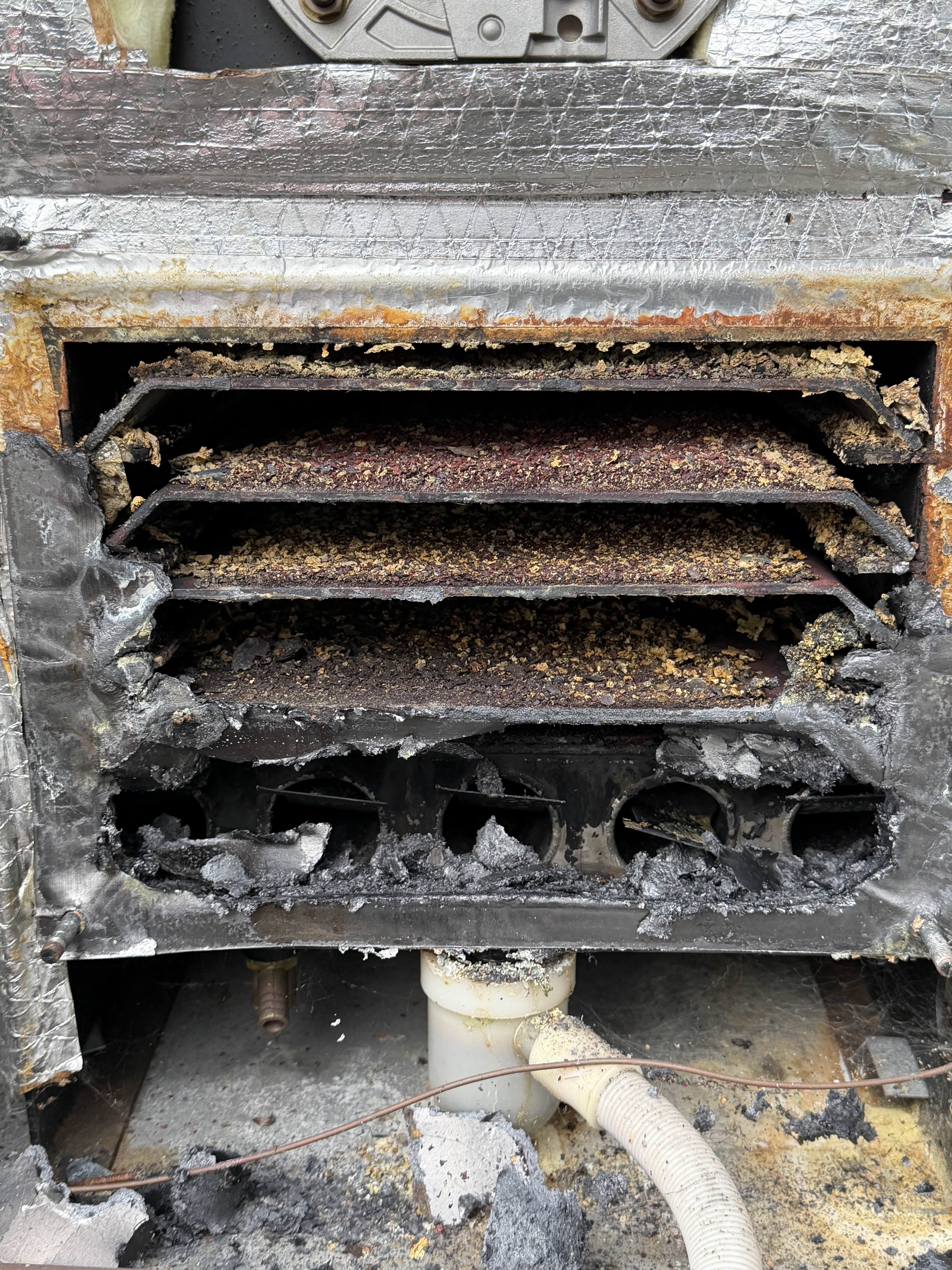 Oil boiler heat exchanger before service thick soot and debris build-up